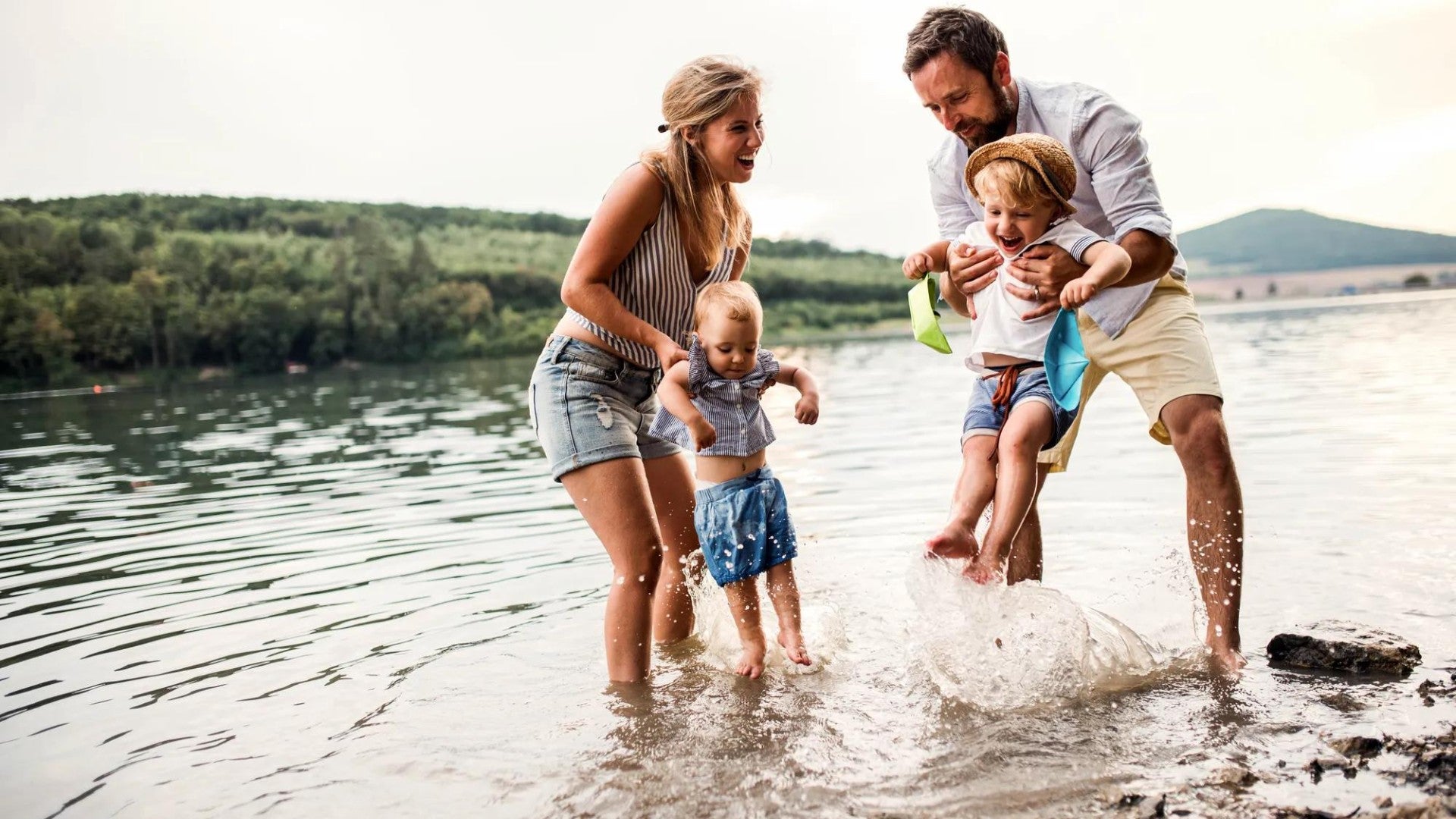 Two parents and two children playing in the water. Two parents and two children playing in the water.