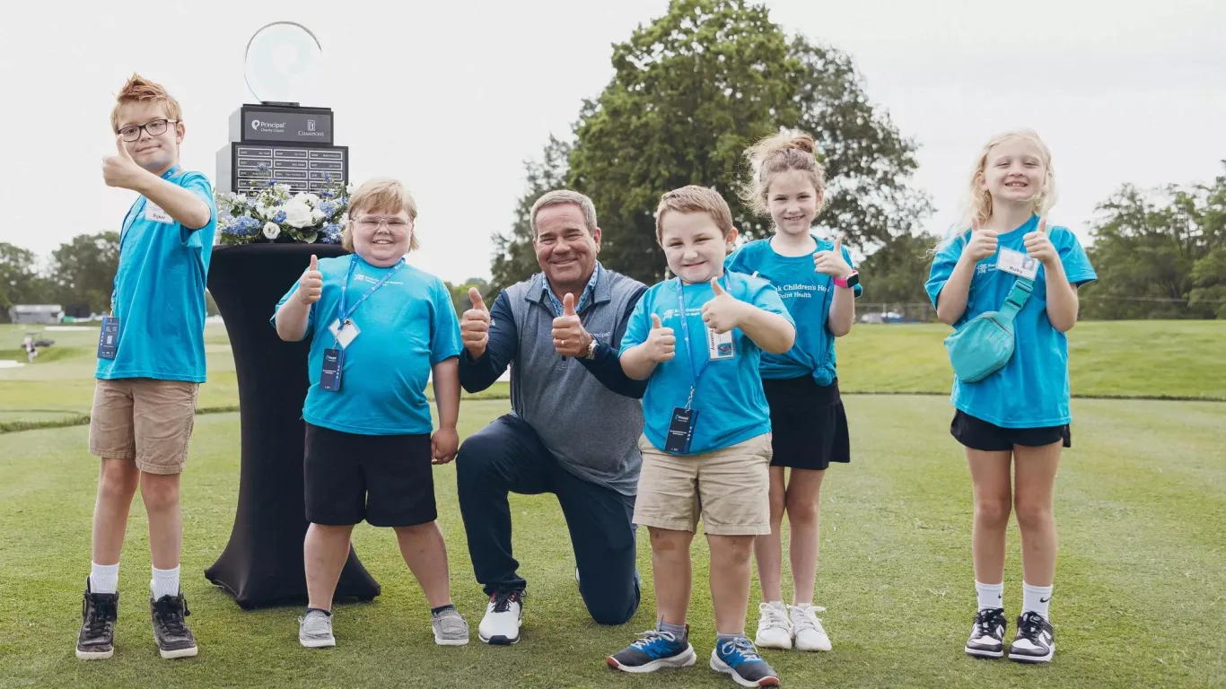 Principal CEO Dan Houston with several kids representing Iowa children's charities