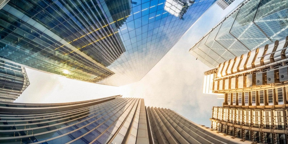 Looking up perspective of financial buildings on a sunny day.