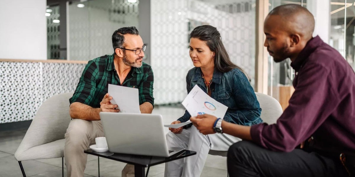 Casual meeting of a business team analyzing financial data.