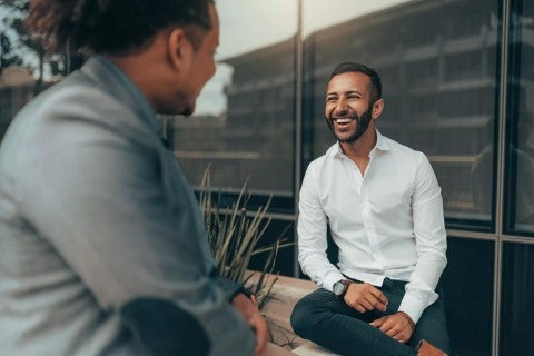 Man smiling in an active conversation