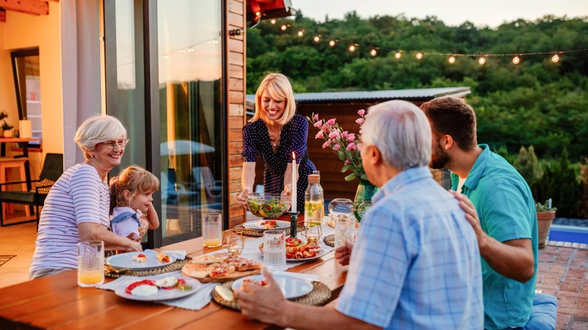 A family eating in their backyard.