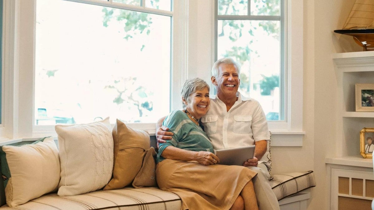 Man and woman sitting together in their home.