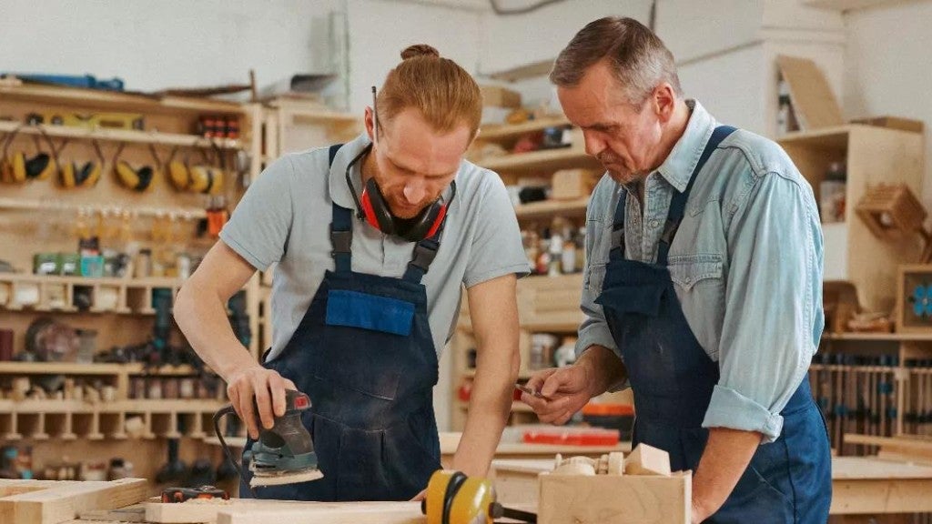 Two men working on a small woodworking business.