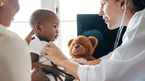 A doctor providing a checkup to a young child