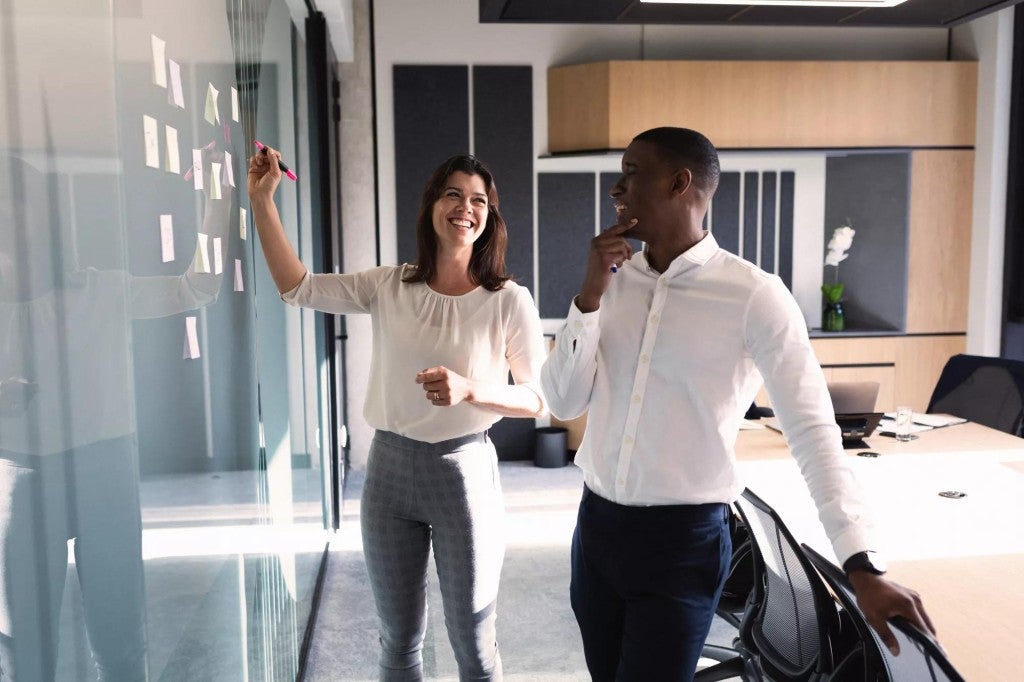 Man and woman brain storming ideas in a meeting room.