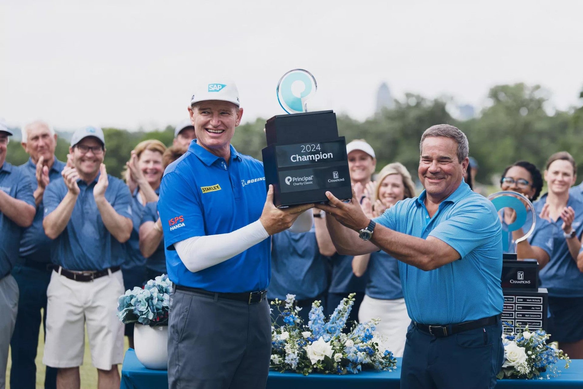 Ernie Els and Dan Houston holding the 2024 Principal Charity Classic trophy.