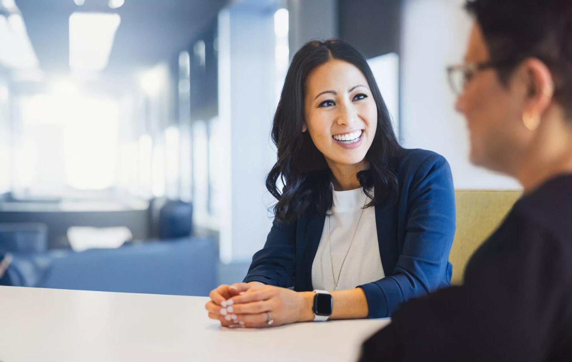 A principal employee meets with a teammate to discuss a new project.