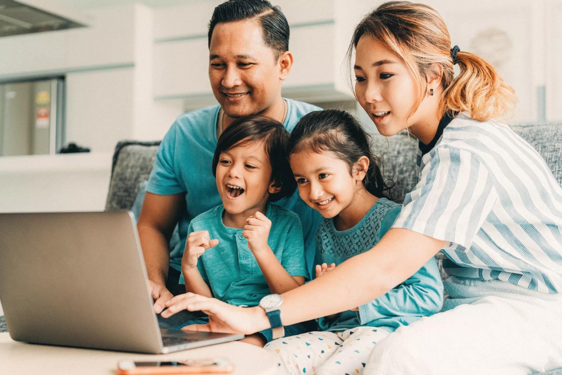 Happy family using laptop together.